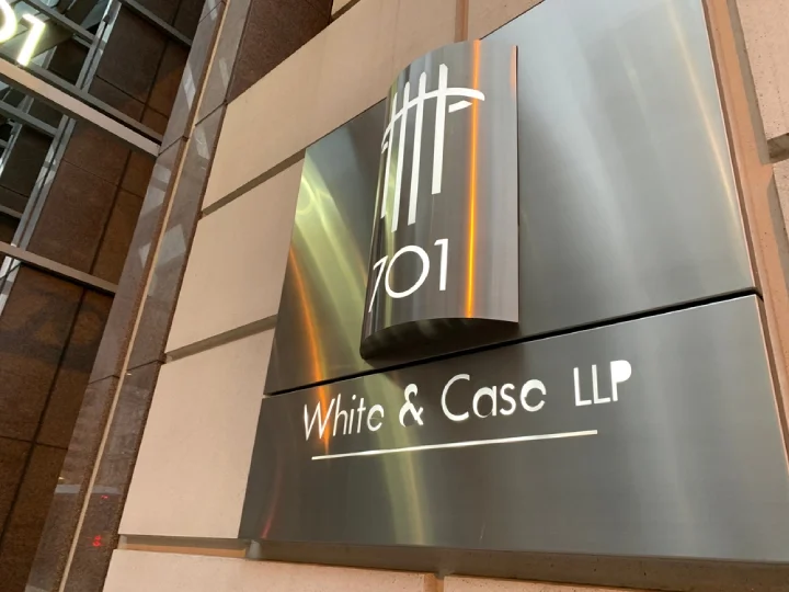 Metal logo of White and Case law firm