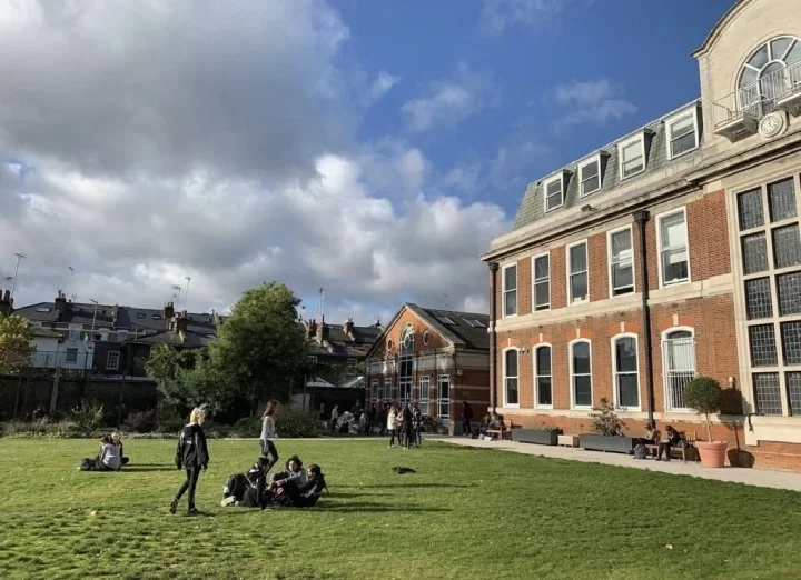 St Paul's Girls School and its students studying on the grass