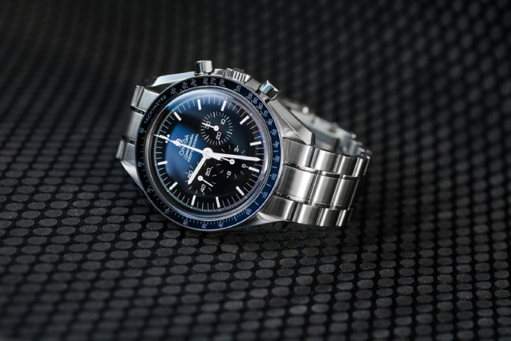 Omega Speedmaster Professional Moonwatch on a dark background, to highlight the elegant features