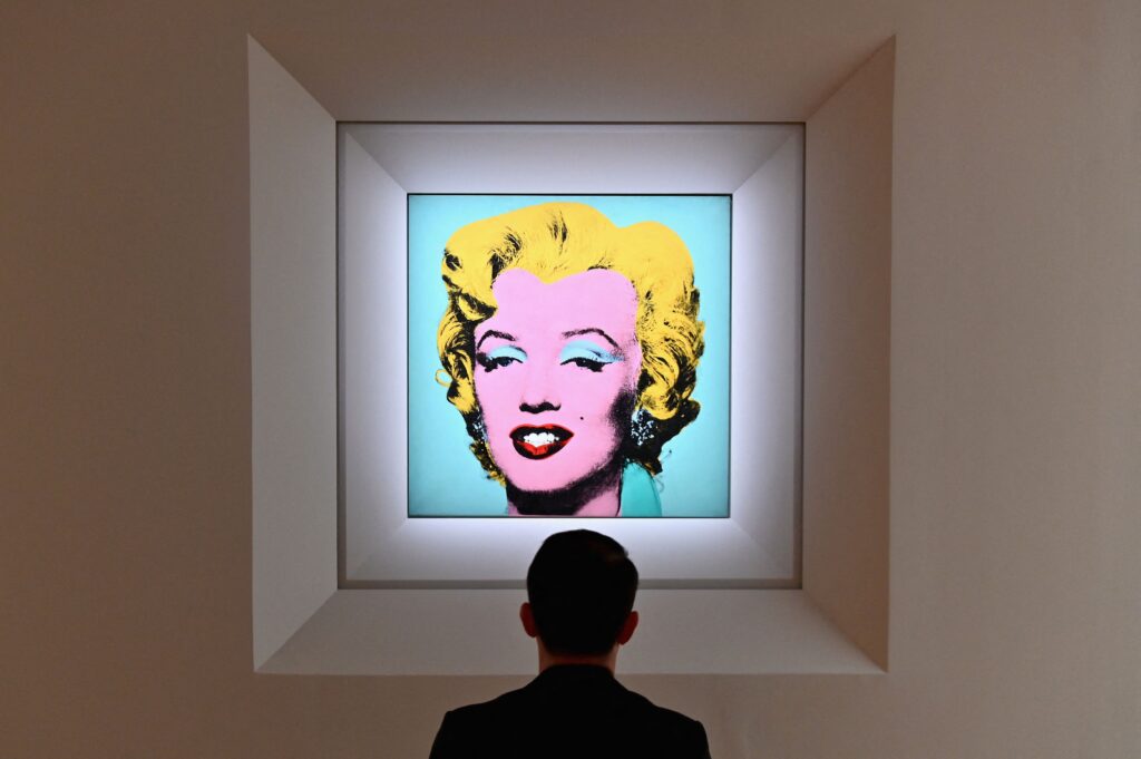 A man looks at Andy Warhol's 'Shot Sage Blue Marilyn' during Christie's 20th and 21st Century Art press preview at Christie's New York on April 29, 2022 in New York City. (Photo by Angela Weiss / AFP) (Photo by ANGELA WEISS/AFP via Getty Images)