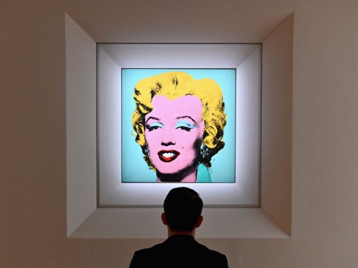 A man looks at Andy Warhol's 'Shot Sage Blue Marilyn' during Christie's 20th and 21st Century Art press preview at Christie's New York on April 29, 2022 in New York City. (Photo by Angela Weiss / AFP) (Photo by ANGELA WEISS/AFP via Getty Images)