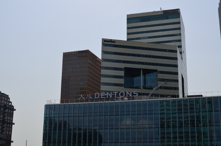 Building with Dentons logo against blue sky