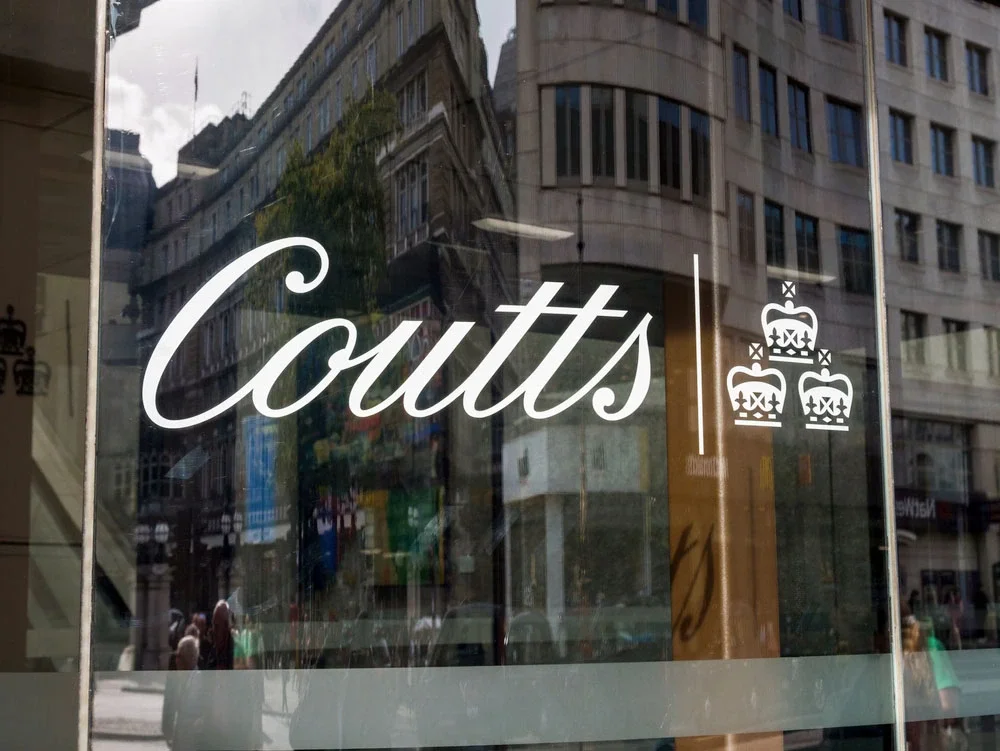 A close-up of a Coutts logo on a window