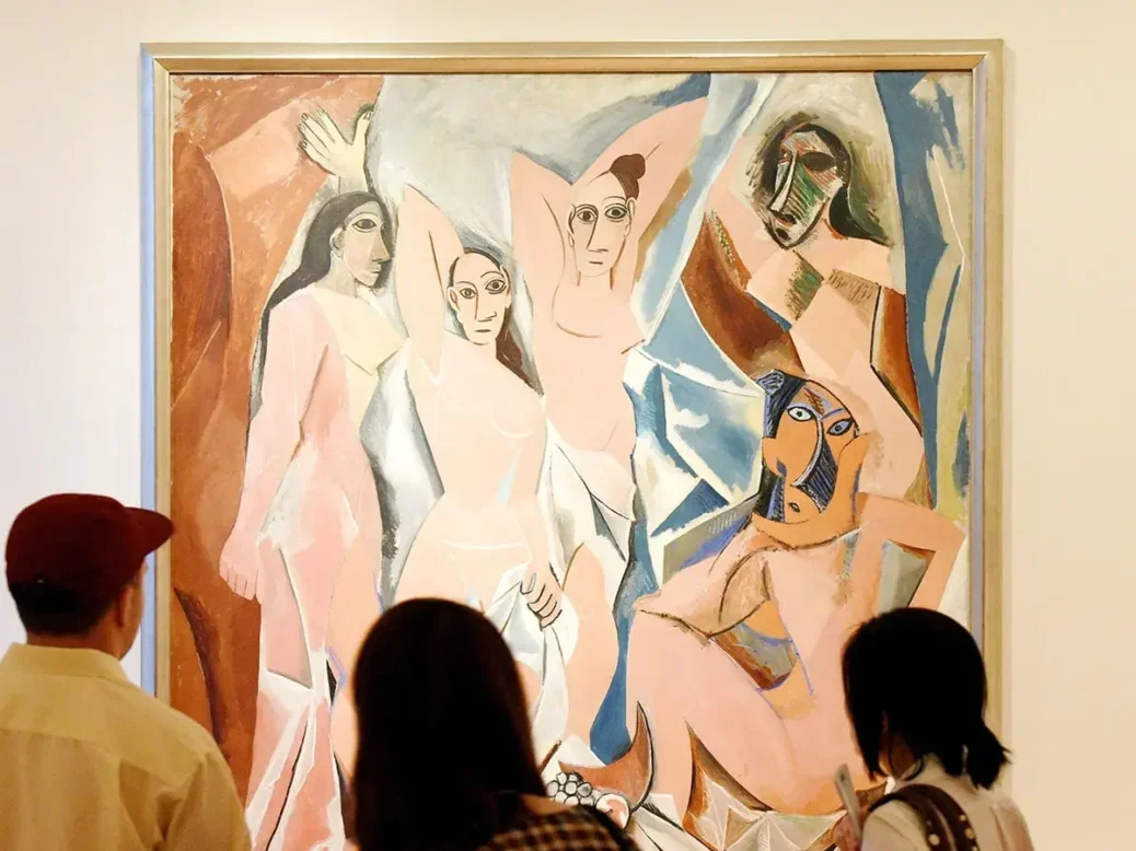 Crowd of people near the Pablo Picasso painting "Les Demoiselles D'Avignon" in Museum of Modern Art in New York City.