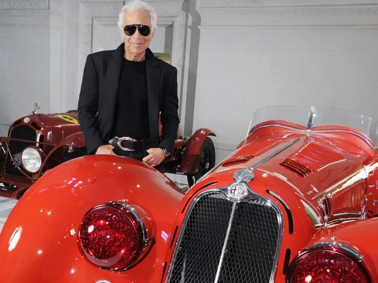 Ralph Lauren standing next to his red Alfa Romeo