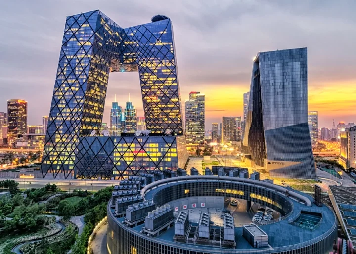 the city of Beijing at sunset, with its tall and illuminated buildings