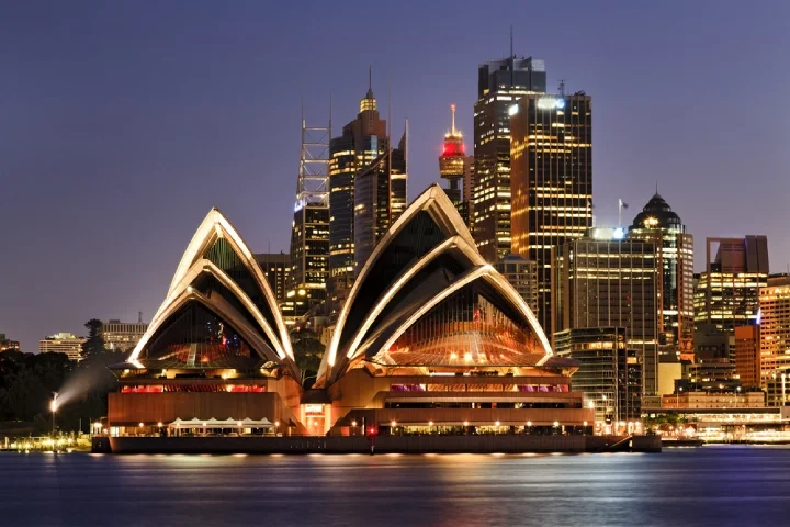 Sydney Opera House at night, illuminated by the city's lights