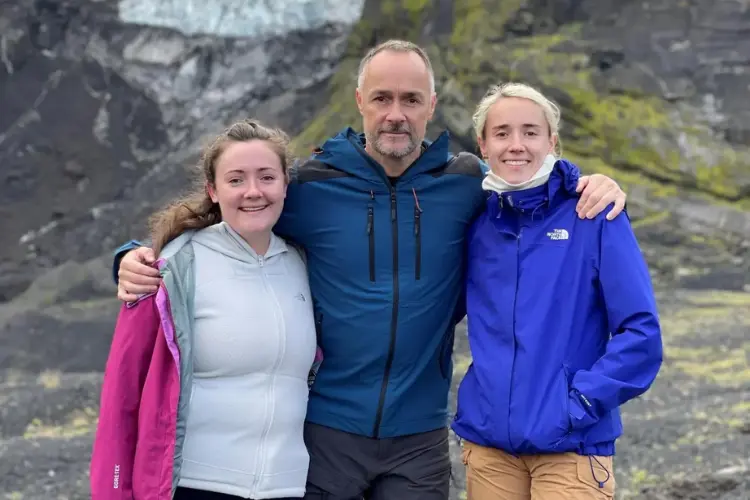 Bill Holmes alongside his two daughters, Lauren and Becky