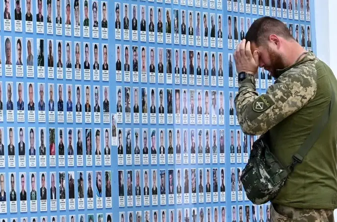 A Ukrainian soldier pays tribute to killed Ukrainian service officers in Kyiv - Bill Browder says Russian oil exports are still funding the country's invasion