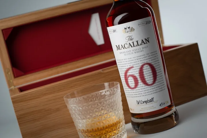 The Macallan Red Collection bottle with its box and a full glass