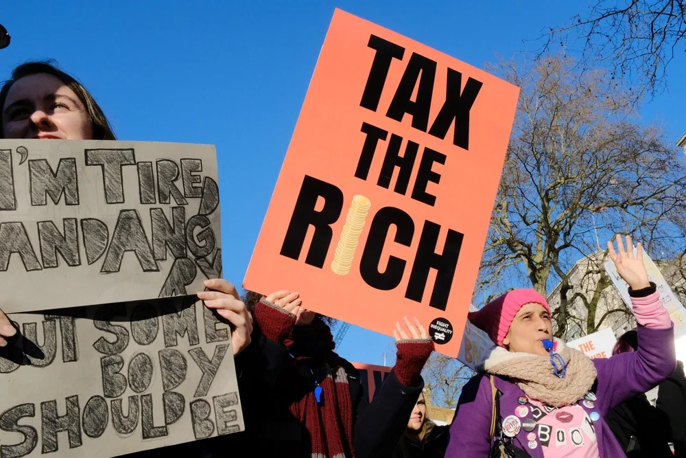 protest sign saying 'tax the rich' held up at a London rally in 2020