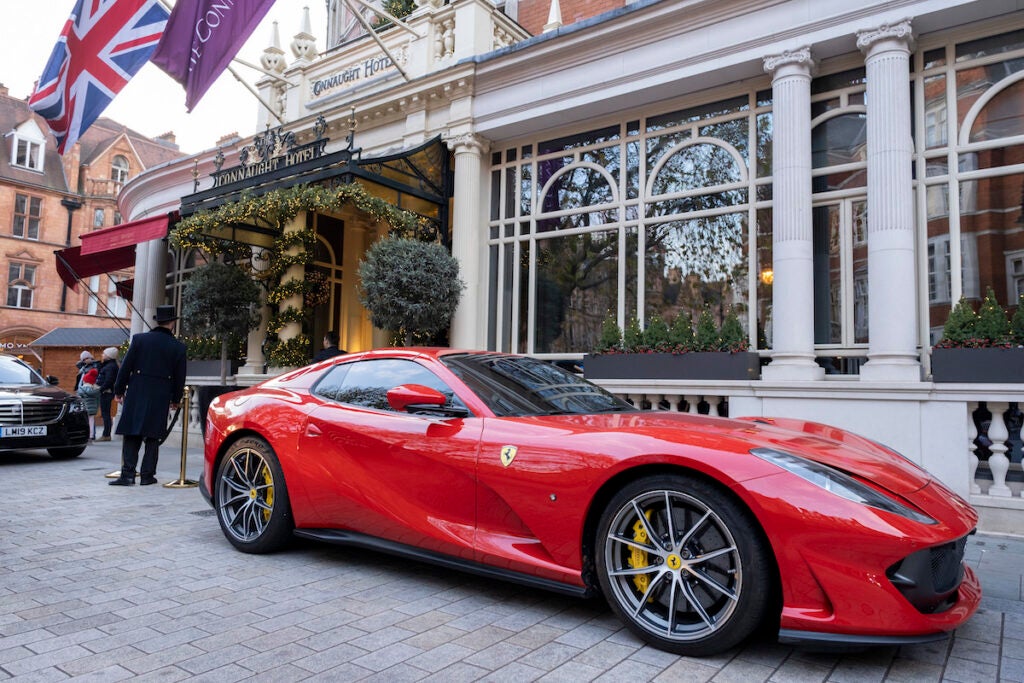 Red Ferrari supercar outside the Connaught Hotel in the exclusive area of Mayfair on 2nd December 2022 in London, United Kingdom. Traditionally wealthy parts of West London, have developed into new affluent playgrounds of the super rich, with influxes of overseas money in particular from the Middle-East, Russia and China. According to recent research by a leading estate agency who specialises in high-end real estate, the UK capital is home to more people of high net worth HNW, and ultra-high net worth UHNW than any other city in the World. (photo by Mike Kemp/In Pictures via Getty Images)