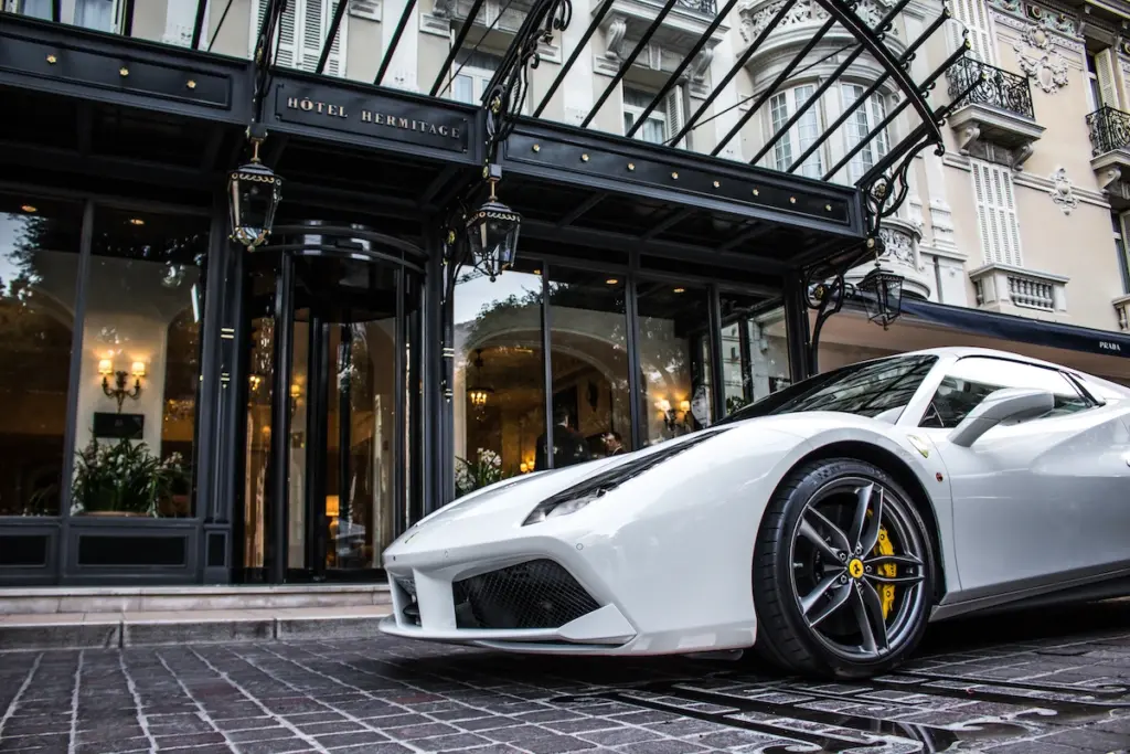 A white Ferrari parked outside the Hermitage Hotel