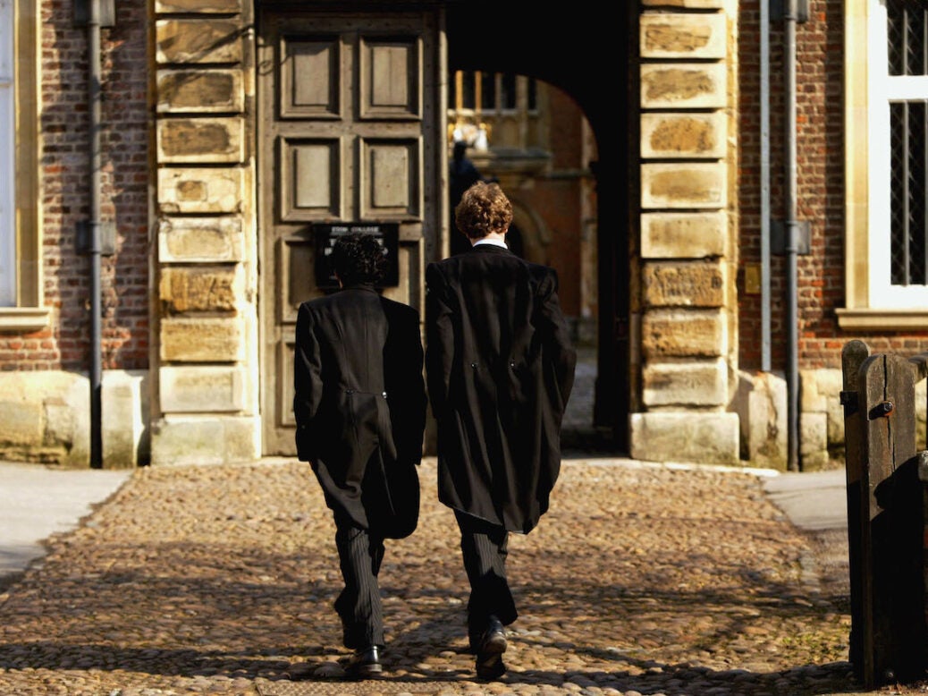 Pupils at Eton College hurry between lessons, March 1, 2004 wearing the school uniform of tailcoats and starched collars, in Eton, England. Dozens of the country's foremost independent schools are facing heavy fines if a government inquiry finds them guilty of operating a fee-fixing cartel.