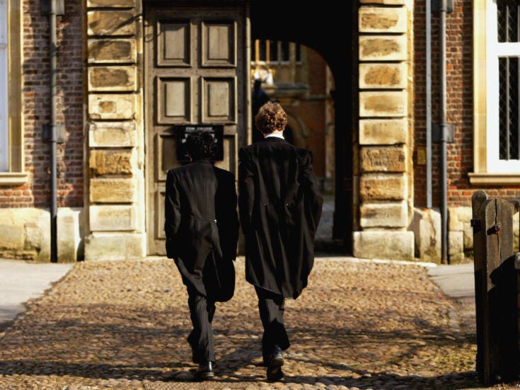Pupils at Eton College hurry between lessons, March 1, 2004 wearing the school uniform of tailcoats and starched collars, in Eton, England. Dozens of the country's foremost independent schools are facing heavy fines if a government inquiry finds them guilty of operating a fee-fixing cartel.