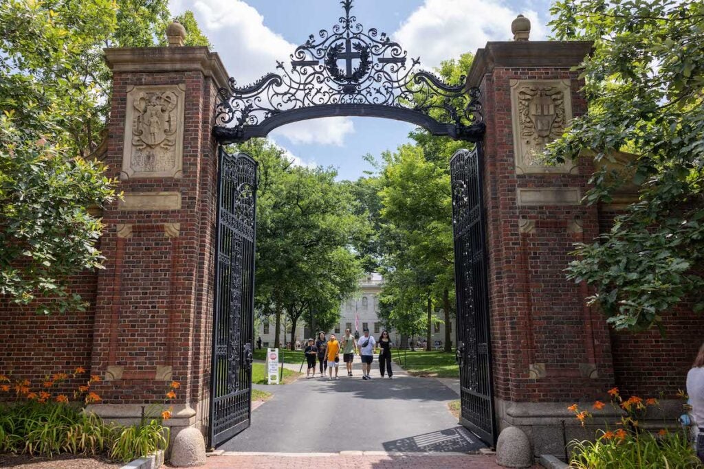 People walk through the gate on Harvard Yard at the Harvard University campus on June 29, 2023 in Cambridge, Massachusetts.