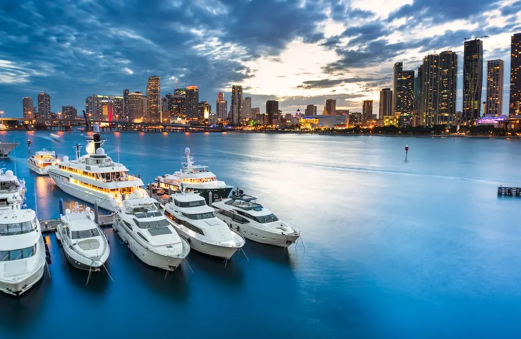 Yachts at dusk in Miami's harbour with city in the background