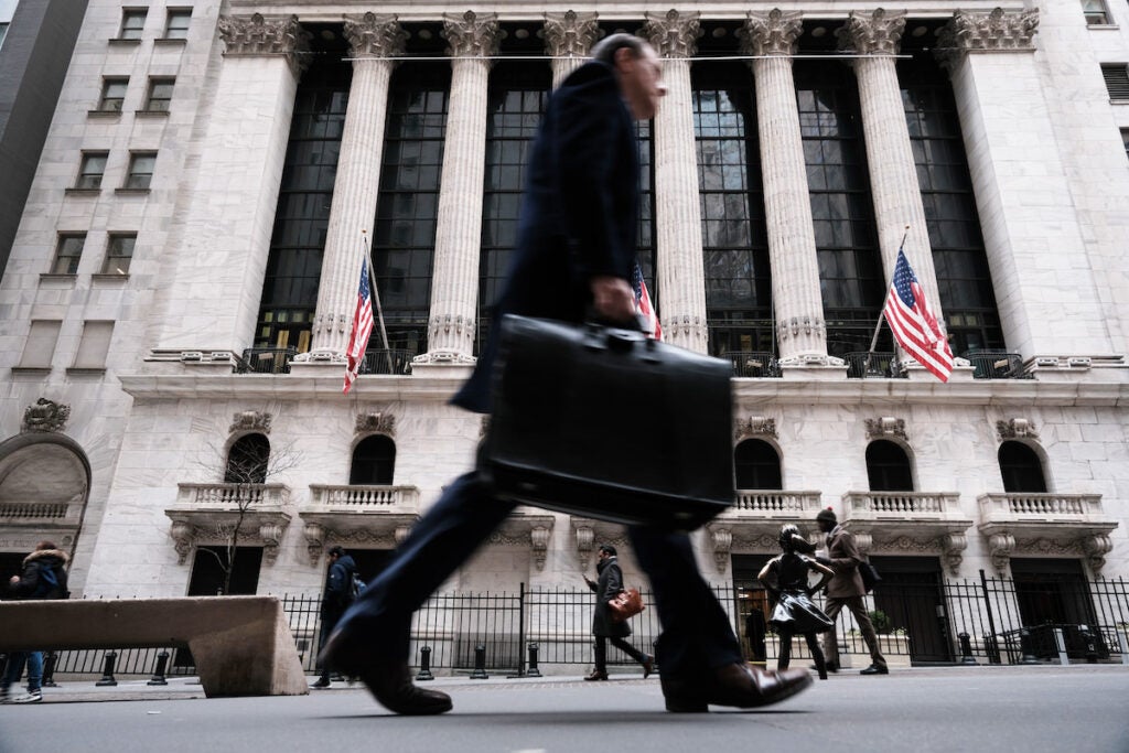 NEW YORK, NEW YORK - MARCH 16: People walk past the New York Stock Exchange (NYSE) on March 16, 2023 in New York City. Stocks fell again in morning trading as investors continue to show concerns over the stability of global banks following the collapse last week of Silicon Valley Bank. (Photo by Spencer Platt/Getty Images)