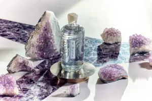 Bottle of X Muse vodka surrounded by amethyst crystals.