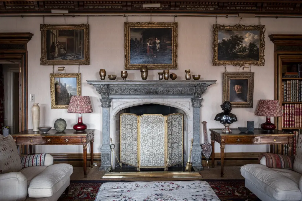 A sitting room with two sofas and a fireplace and contemporary crafts on the mantlepiece 