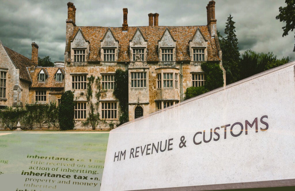 A cut out of a large house with a dictionary entry of 'inheritance tax' and a HMRC sign