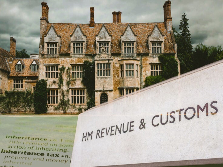 A cut out of a large house with a dictionary entry of 'inheritance tax' and a HMRC sign