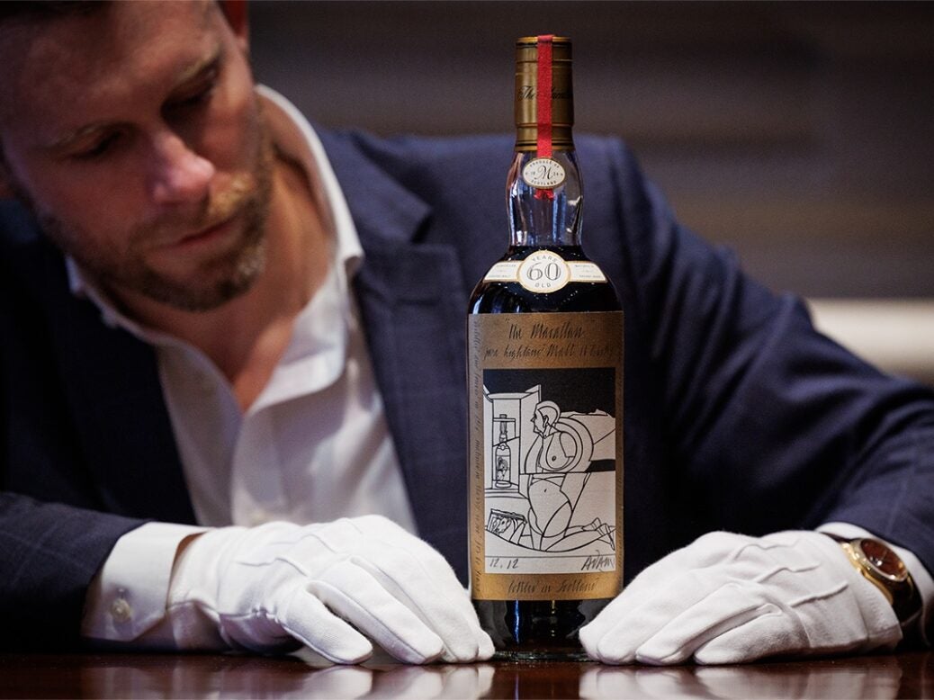 Jonny Fowle, Sotheby's Global Head of Whisky, with the Macallan 1926