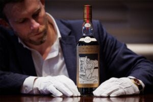 Jonny Fowle, Sotheby's Global Head of Whisky, with the Macallan 1926