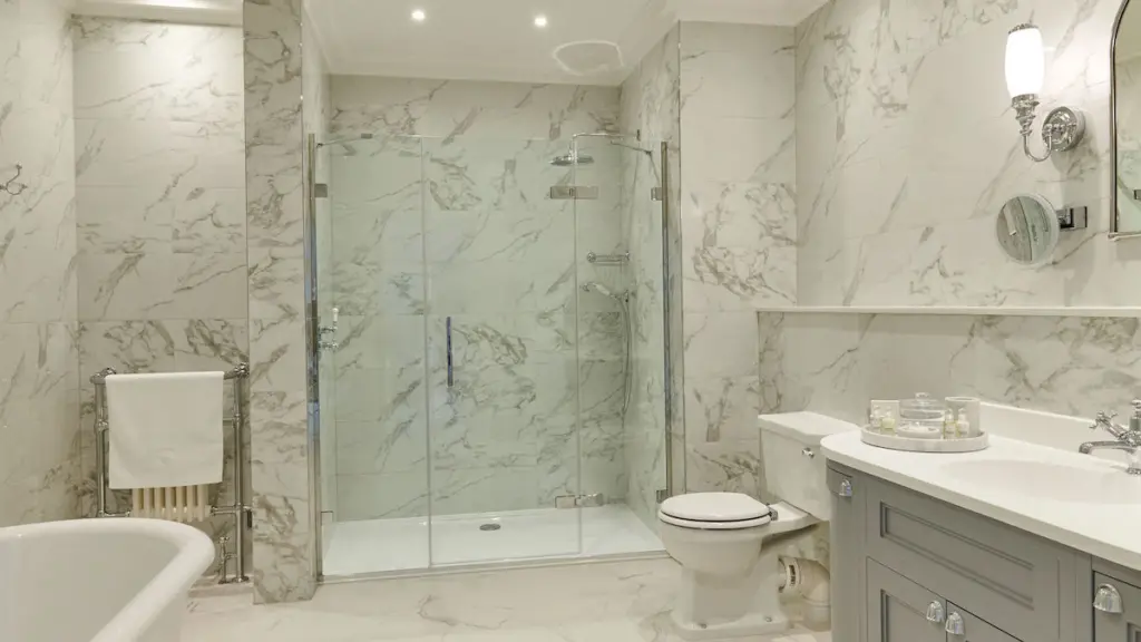 A marble bathroom with walk in shower