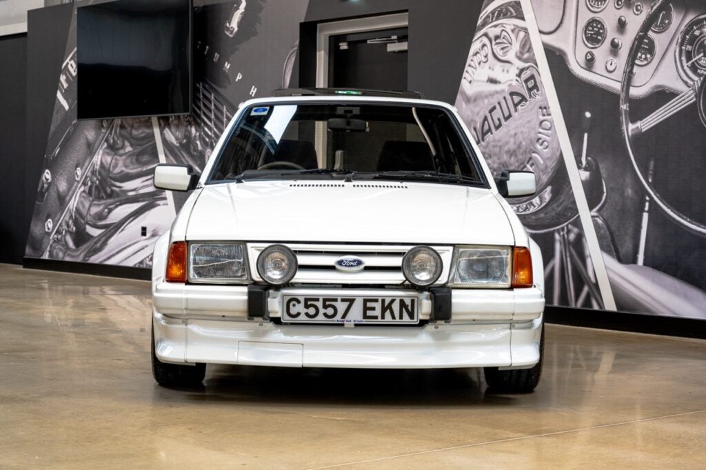 White Ford Escort RS Turbo in a showroom