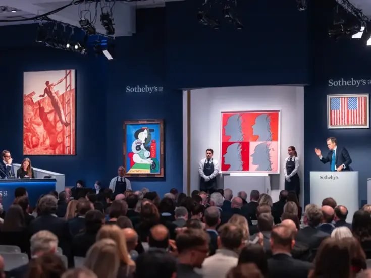 An auction at Sotheby's showing Sotheby's Chairman Auctioneer OliverBarker fielding bids during the Emily Fisher Landau Collection auction