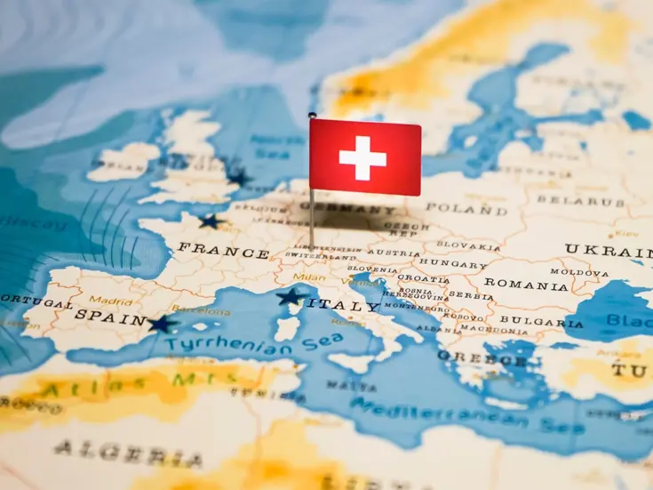 Stock image of Switzerland marked on world map with Swiss flag