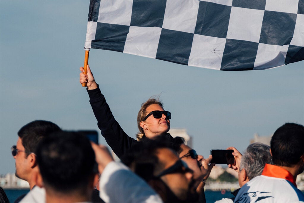 A woman waves a chequered flag at the inaugural E1 race in Saudi Arabia