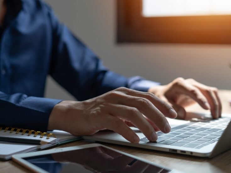 man typing on Laptop